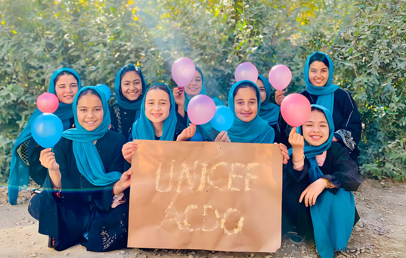 Nazanin and her classmate showcasing their handmade works